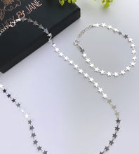 Load image into Gallery viewer, Sterling silver multi stars necklace next to a matching silver stars bracelet 